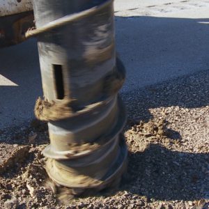 post removal in frozen ground drilling with hydraulic attachment for a skid steer