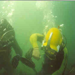 diver operating underwater grinder metal