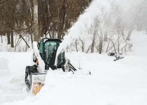 Hydraulic Snowblower on skid steer blowing snow